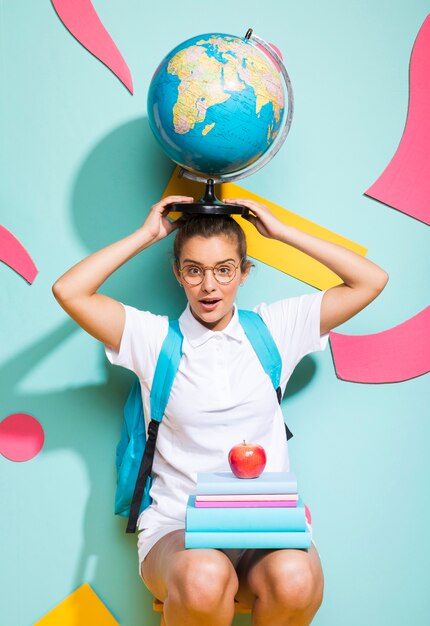 Portrait of schoolgirl with globe