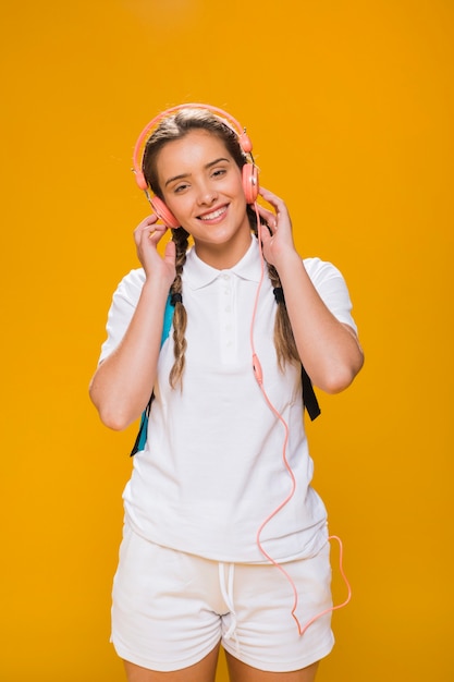 Free photo portrait of schoolgirl on yellow background