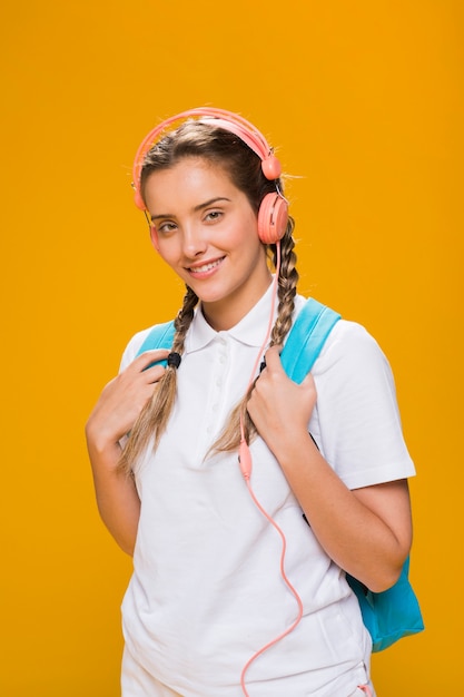 Portrait of schoolgirl on yellow background