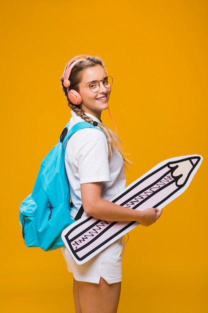 Portrait of schoolgirl on yellow background