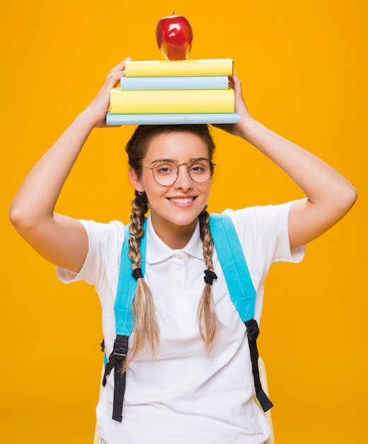 Portrait of schoolgirl on yellow background