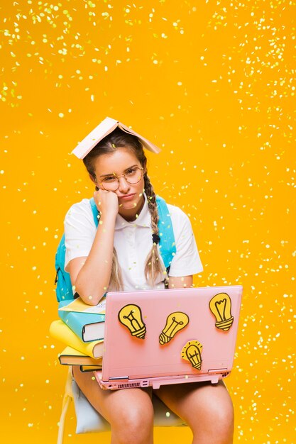 Portrait of schoolgirl on yellow background