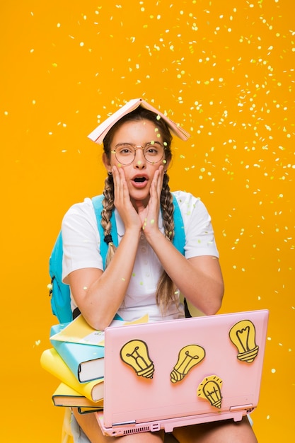 Portrait of schoolgirl on yellow background