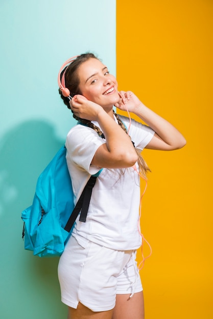 Portrait of schoolgirl on yellow and blue background