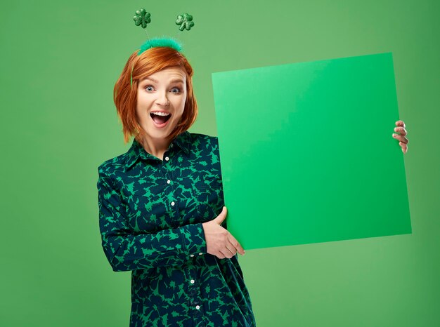 Portrait of screaming woman holding green banner