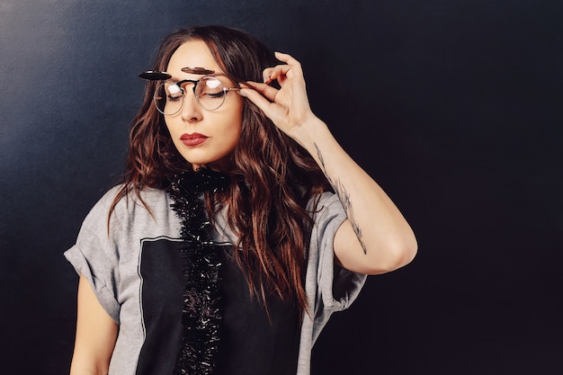 Portrait of seductive hipster woman wearing glasses