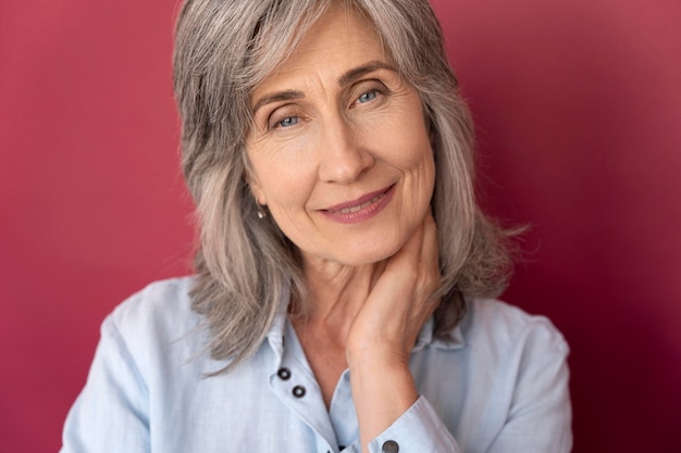 Portrait of senior gray-haired smiley woman