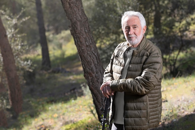 Free photo portrait senior man hiking on mountain