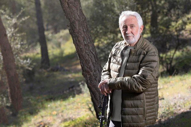 Portrait senior man hiking on mountain