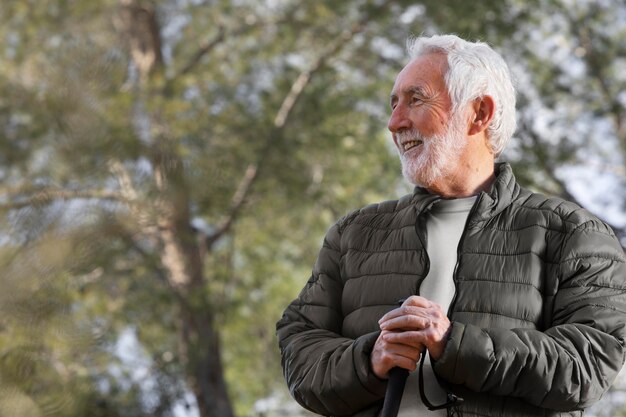 Portrait senior man hiking on mountain