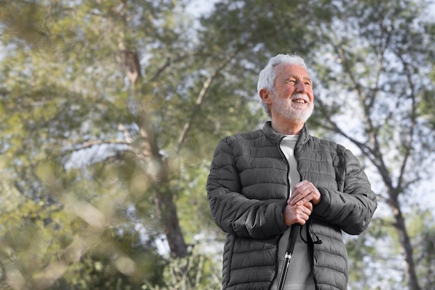 Free photo portrait senior man hiking on mountain