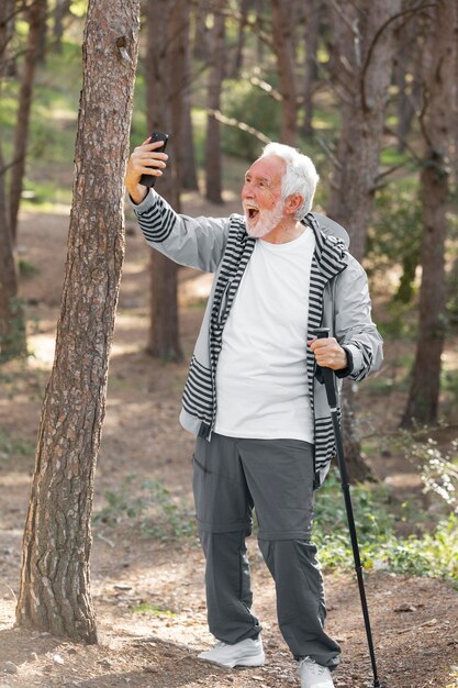 Portrait senior man hiking on mountain