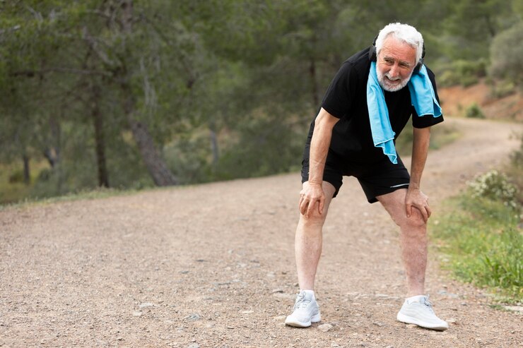 Free Photo portrait senior man jogging on mountain