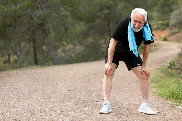 Portrait senior man jogging on mountain