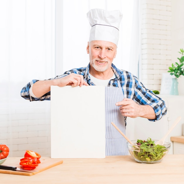 Free photo portrait of a senior man showing blank screen digital tablet