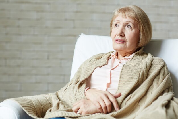 Portrait of senior woman on couch