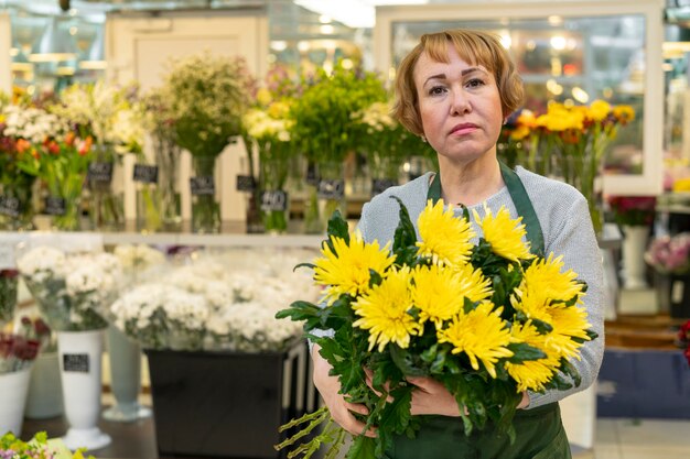 Portrait of senior woman holding flowers