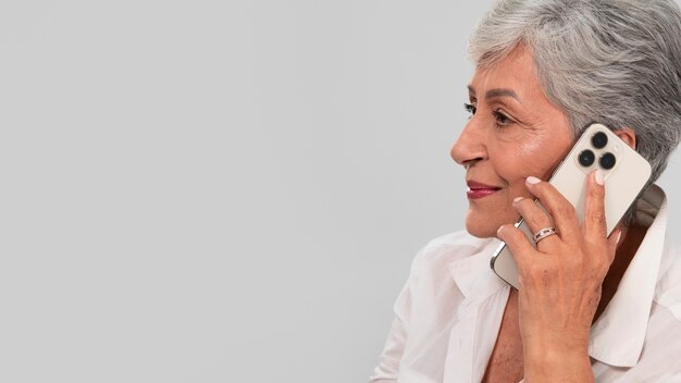 Portrait of senior woman with smartphone