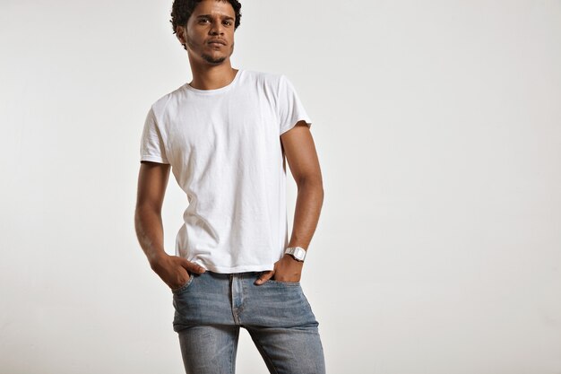Portrait of a sensual black young model in unlabeled white t-shirt, light blue jeans and wearing a vintage digital watch