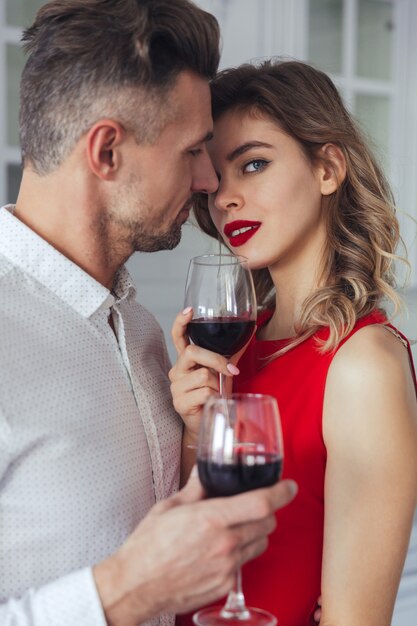 Portrait of a sensual romantic smart dressed couple drinking