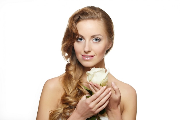 Free photo portrait of sensual smiling beautiful woman with white rose on white