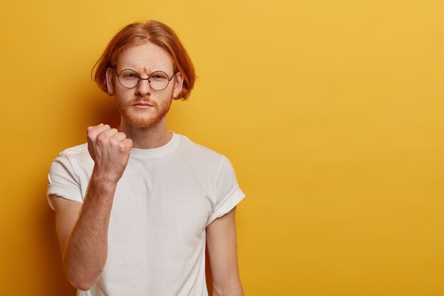 Portrait of serious angry man shows clenched fist