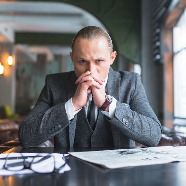 Portrait of a serious businessman in caf�