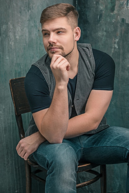 Portrait of serious man sitting on the chair