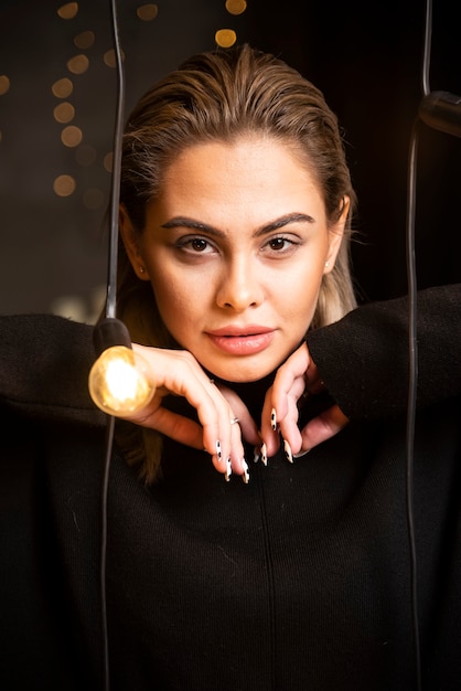 Free photo portrait of serious woman in black sweater standing and posing