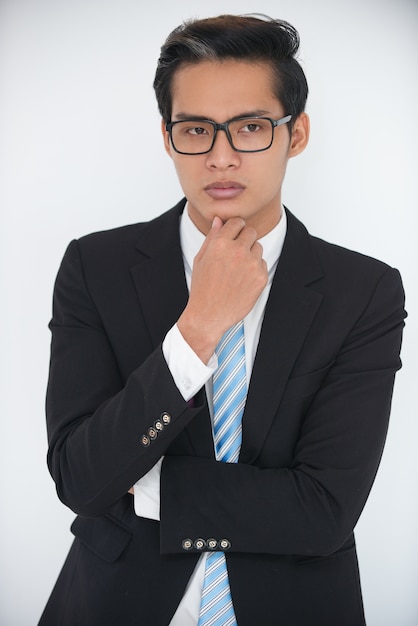 Portrait of serious young businessman thinking