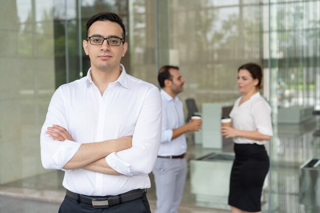 Portrait of serious young Caucasian executive wearing eyeglasses