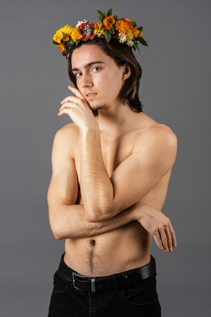 Free photo portrait of shirtless man with flower crown