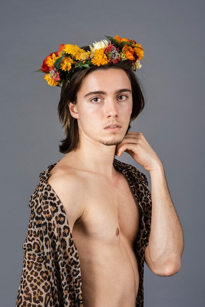 Free photo portrait of shirtless man with flower crown