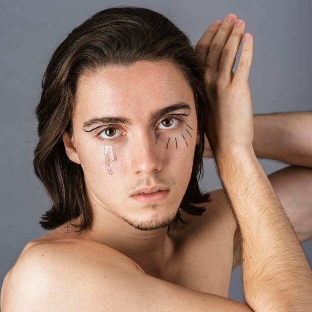 Portrait of shirtless man with make-up