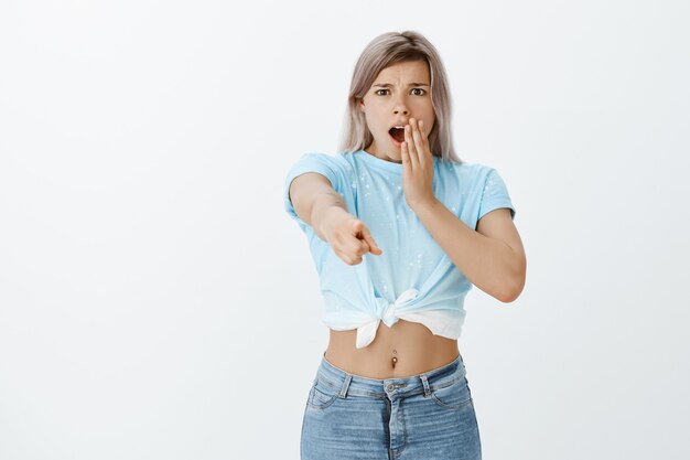 Portrait of shocked blonde girl posing in the studio