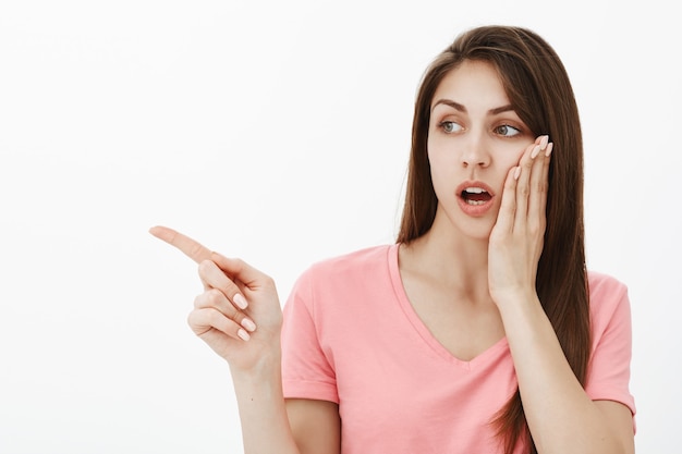 Portrait of shocked brunette woman posing in the studio