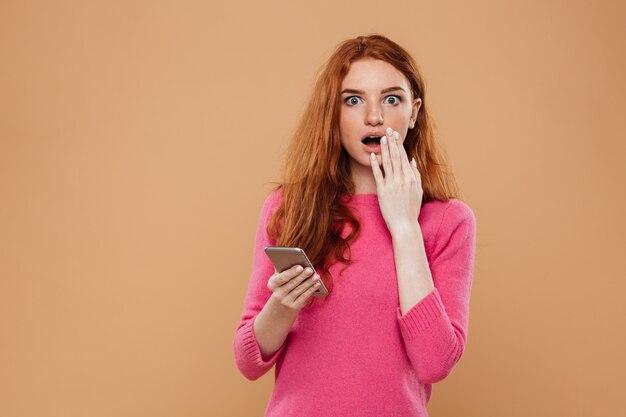 Portrait of a shocked pretty redhead girl