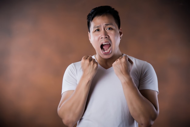 portrait of shocked stunned surprised young man eyes and mouth wide open