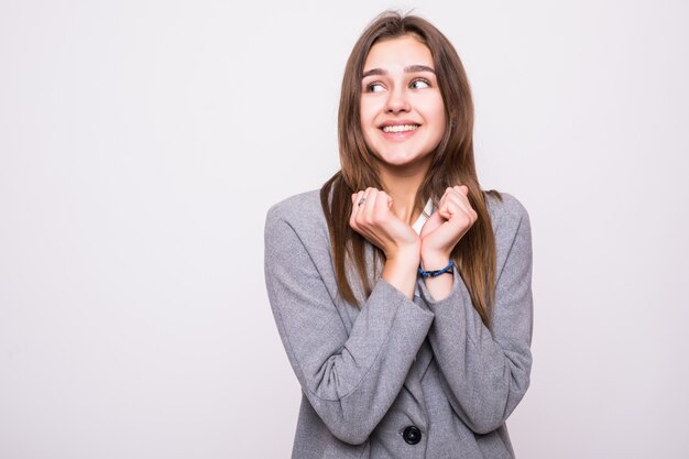 Portrait of shocked woman with mouth open looking away on a gray background