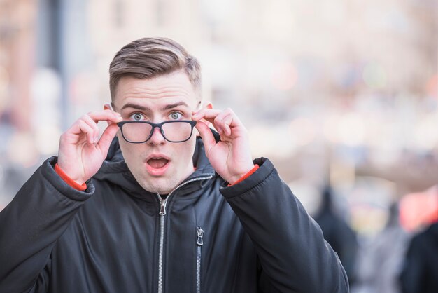 Portrait of a shocked young man at outdoors