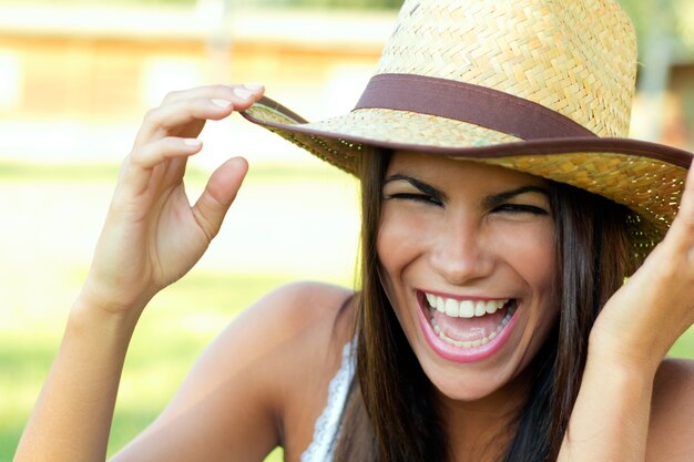 Portrait shot of a beautiful woman with hat in a park