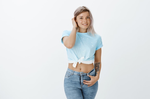 Free photo portrait of shy blonde girl posing in the studio