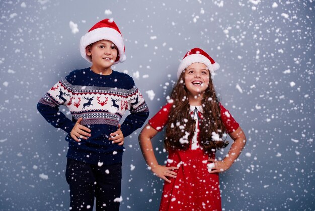 Portrait of siblings among snow falling