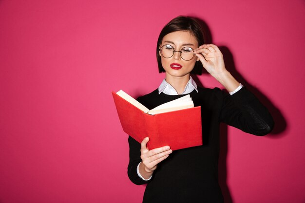 Portrait of a smart attractive businesswoman reading a book