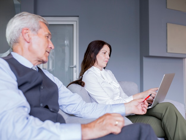 Free photo portrait of smart business partners looking at laptop