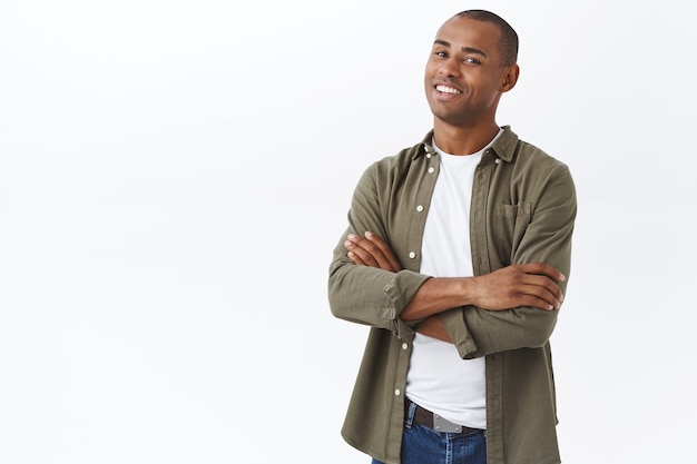 Portrait of smart, professional african-american man, standing with hands crossed on chest, confident pose