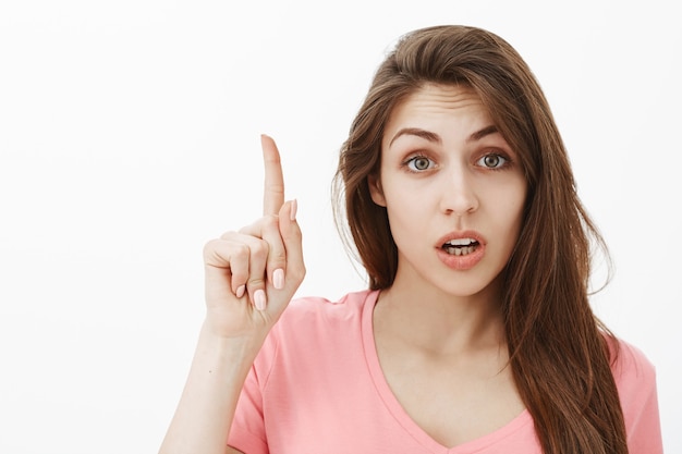 Portrait of smart talkative brunette woman posing in the studio