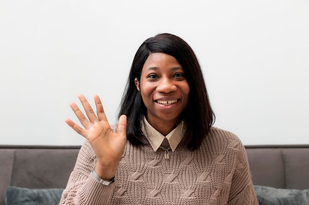 Portrait of smiley businesswoman waving