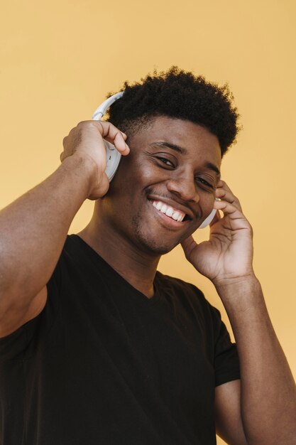 Portrait of smiley man listening to music on headphones