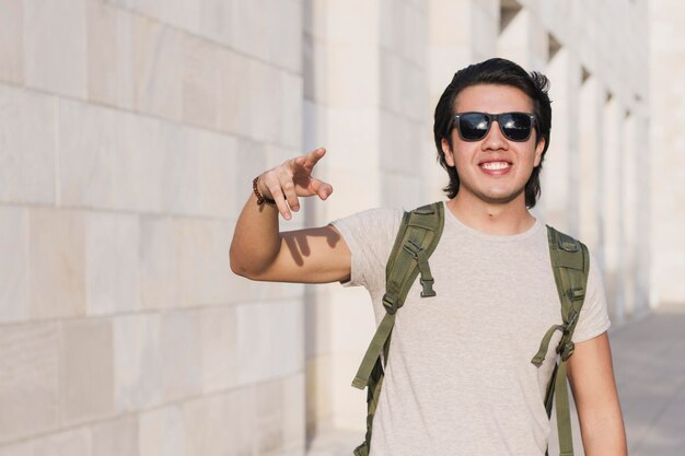 Portrait smiley man showing peace sign